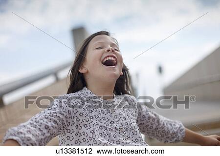 Girl laughing outdoors View Large Photo Image Stock Image - Girl laughing outdoors. Fotosearch