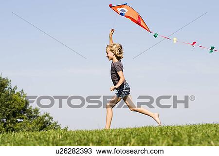 Girl playing with kite outdoors View Large Photo Image Stock Image - Girl playing with kite outdoors. Fotosearch