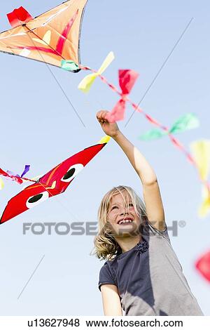 Girl playing with kite outdoors View Large Photo Image Stock Photo - Girl playing with kite outdoors. Fotosearch