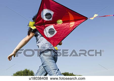 Girl playing with kite outdoors View Large Photo Image Stock Photo - Girl playing with kite outdoors. Fotosearch