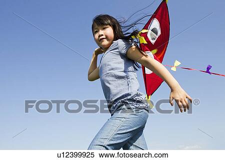 Girl playing with kite outdoors View Large Photo Image Stock Photography - Girl playing with kite outdoors. Fotosearch