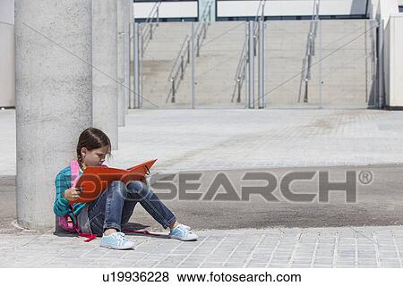 Girl reading folder outdoors View Large Photo Image Stock Photo - Girl reading folder outdoors. Fotosearch