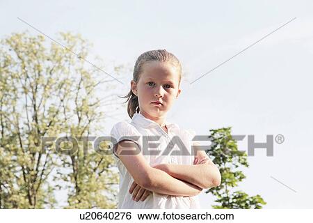 Girl standing with arms crossed outdoors View Large Photo Image Stock Photograph - Girl standing with arms crossed outdoors. Fotosearch