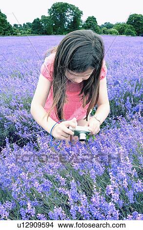 Girl taking pictures of flowers View Large Photo Image Picture - Girl taking pictures of flowers. Fotosearch