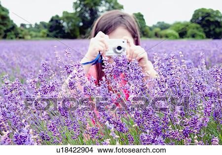 Girl taking pictures of flowers View Large Photo Image Picture - Girl taking pictures of flowers. Fotosearch
