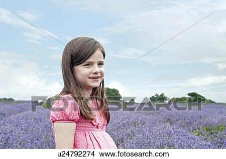 Girl walking in field of flowers View Large Photo Image Picture - Girl walking in field of flowers. Fotosearch