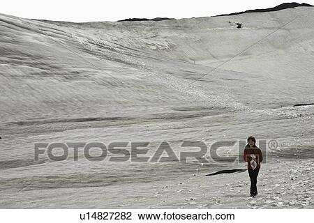 Girl walking in snowy landscape View Large Photo Image Stock Image - Girl walking in snowy landscape. Fotosearch