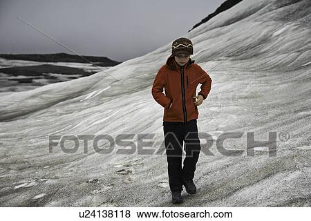 Girl walking on snowy hillside View Large Photo Image Stock Photo - Girl walking on snowy hillside. Fotosearch