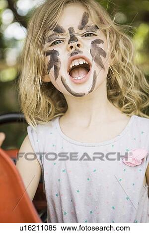 Girl wearing face paint outdoors View Large Photo Image Stock Photography - Girl wearing face paint outdoors. Fotosearch