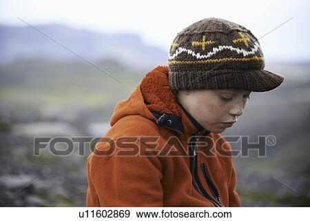 Stock Photo - Girl wearing knitted cap outdoors. Fotosearch