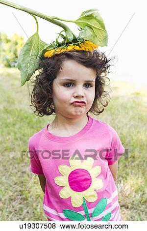 Stock Photo - Girl wearing wildflower on her head. Fotosearch