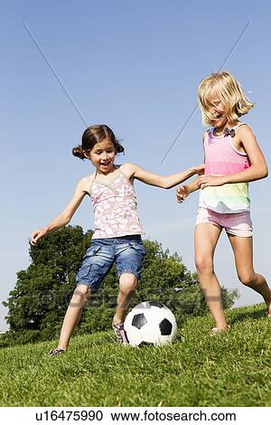 Girls playing soccer in field View Large Photo Image Stock Image - Girls playing soccer in field. Fotosearch