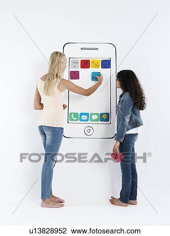 Stock Image - Girls playing with drawing of smartphone. Fotosearch
