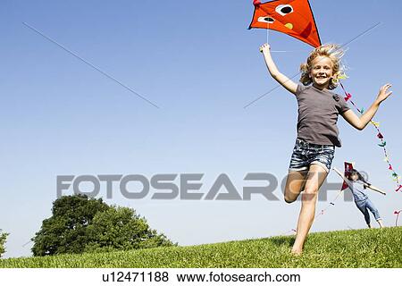 Girls playing with kites outdoors View Large Photo Image Stock Photo - Girls playing with kites outdoors. Fotosearch