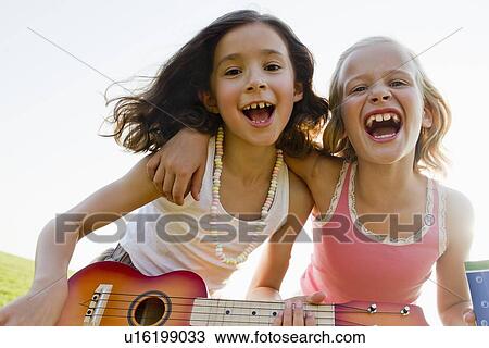 Girls singing together outdoors View Large Photo Image Stock Image - Girls singing together outdoors. Fotosearch