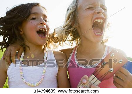 Girls singing together outdoors View Large Photo Image Stock Photo - Girls singing together outdoors. Fotosearch