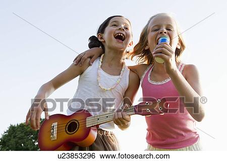 Girls singing together outdoors View Large Photo Image Stock Photograph - Girls singing together outdoors. Fotosearch