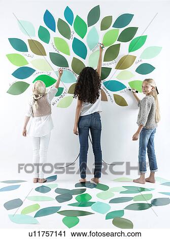 Girls writing on tree on wall View Large Photo Image Stock Image - Girls writing on tree on wall. Fotosearch