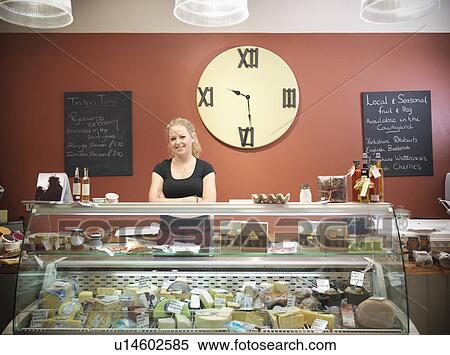 Grocer standing behind counter in shop View Large Photo Image Stock Photography - Grocer standing behind counter in shop. Fotosearch