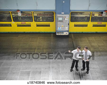 High angle view of engineers in discussion in car factory View Large Photo Image Stock Photograph - High angle view of engineers in discussion in car factory. Fotosearch