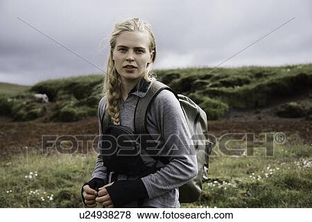 Hiker carrying backpack on hillside View Large Photo Image Stock Photo - Hiker carrying backpack on hillside. Fotosearch