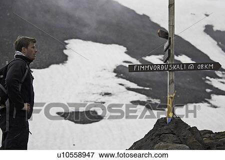 Hiker reading sign on trail View Large Photo Image Stock Photo - Hiker reading sign on trail. Fotosearch