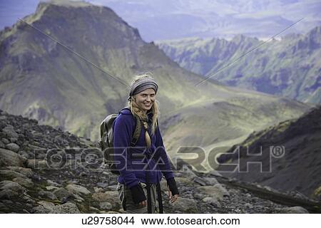 Hiker standing on rocky hillside View Large Photo Image Picture - Hiker standing on rocky hillside. Fotosearch