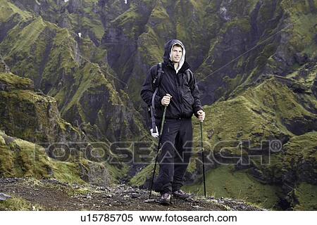 Hiker standing on rocky hillside View Large Photo Image Stock Photography - Hiker standing on rocky hillside. Fotosearch