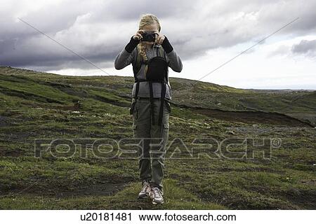 Hiker taking pictures on hillside View Large Photo Image Stock Image - Hiker taking pictures on hillside. Fotosearch