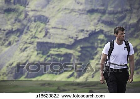 Hiker walking in rural landscape View Large Photo Image Stock Image - Hiker walking in rural landscape. Fotosearch