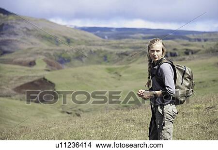 Hiker wearing backpack on hillside View Large Photo Image Picture - Hiker wearing backpack on hillside. Fotosearch