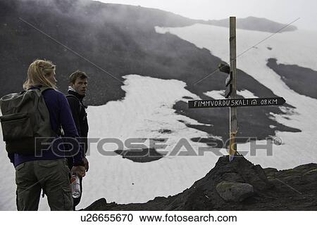 Hikers reading sign on trail View Large Photo Image Stock Image - Hikers reading sign on trail. Fotosearch