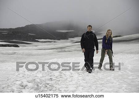 Hikers walking in snowy landscape View Large Photo Image Stock Photography - Hikers walking in snowy landscape. Fotosearch