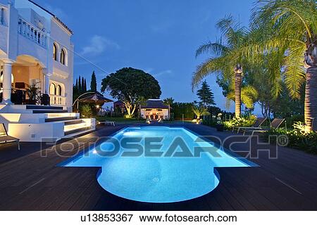 Illuminated pool outside villa View Large Photo Image Stock Photo - Illuminated pool outside villa. Fotosearch