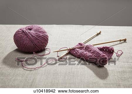 Knitting on needles attached to yarn View Large Photo Image Stock Image - Knitting on needles attached to yarn. Fotosearch