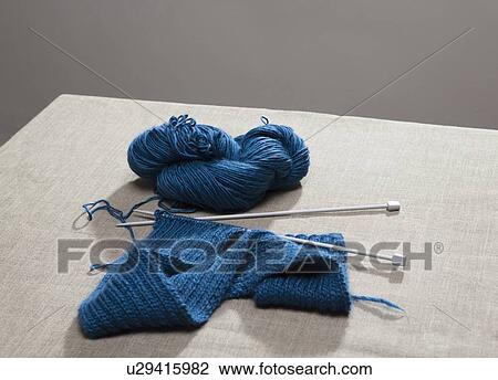 Stock Image - Knitting on needles attached to yarn. Fotosearch