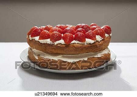 Picture - Layer cake with cream and strawberries. Fotosearch