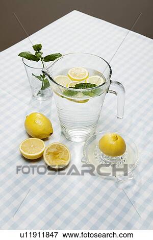 Lemons, herbs and pitcher of water View Large Photo Image Stock Photo - Lemons, herbs and pitcher of water. Fotosearch