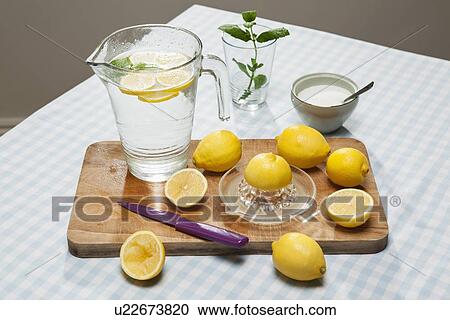 Lemons, juicer and pitcher of water View Large Photo Image Stock Image - Lemons, juicer and pitcher of water. Fotosearch