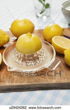 Lemons, juicer and pitcher of water View Large Photo Image Stock Image - Lemons, juicer and pitcher of water. Fotosearch