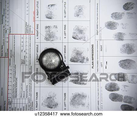 Loupe over fingerprints on arrest form View Large Photo Image Stock Photo - Loupe over fingerprints on arrest form. Fotosearch