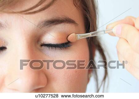 Make up artist applying eyeshadow View Large Photo Image Stock Photo - Make up artist applying eyeshadow. Fotosearch