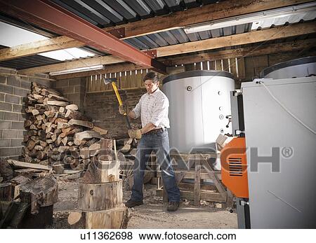 Man chopping wood in shed View Large Photo Image Stock Photo - Man chopping wood in shed. Fotosearch