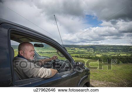 Man driving car in rural landscape View Large Photo Image Stock Photograph - Man driving car in rural landscape. Fotosearch