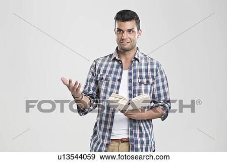 Man gesturing and reading book View Large Photo Image Stock Photo - Man gesturing and reading book. Fotosearch