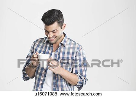 Man having cup of coffee View Large Photo Image Stock Photo - Man having cup of coffee. Fotosearch