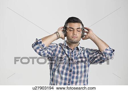 Man listening to headphones View Large Photo Image Picture - Man listening to headphones. Fotosearch
