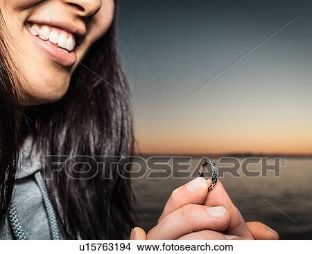 Man offering girlfriend ring outdoors View Large Photo Image Picture - Man offering girlfriend ring outdoors. Fotosearch