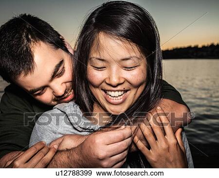 Stock Photo - Man offering girlfriend ring outdoors. Fotosearch