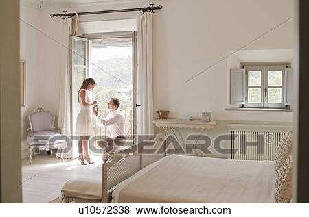 Man proposing to girlfriend in window View Large Photo Image Stock Photo - Man proposing to girlfriend in window. Fotosearch